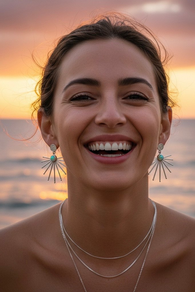 Sofi Jewelry sun-inspired earrings worn at sunset by the ocean