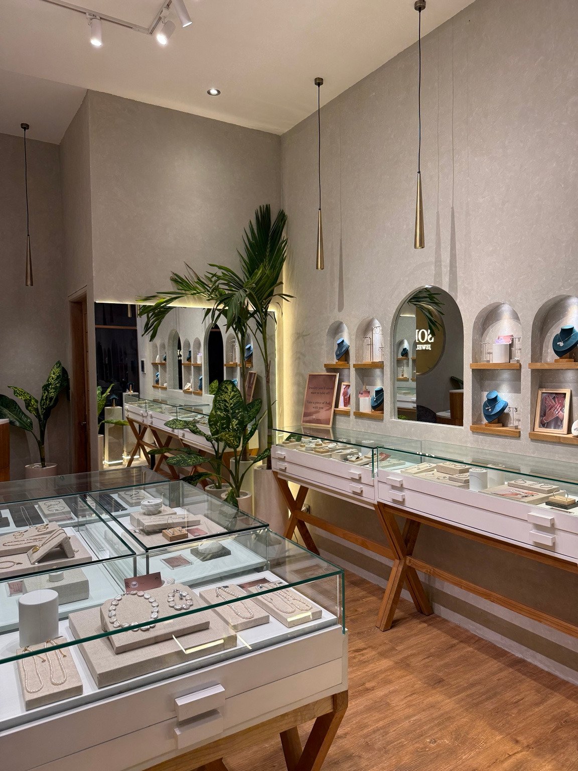 Inside Sofi Jewelry: jewellery displays, arched mirrors and tropical plants